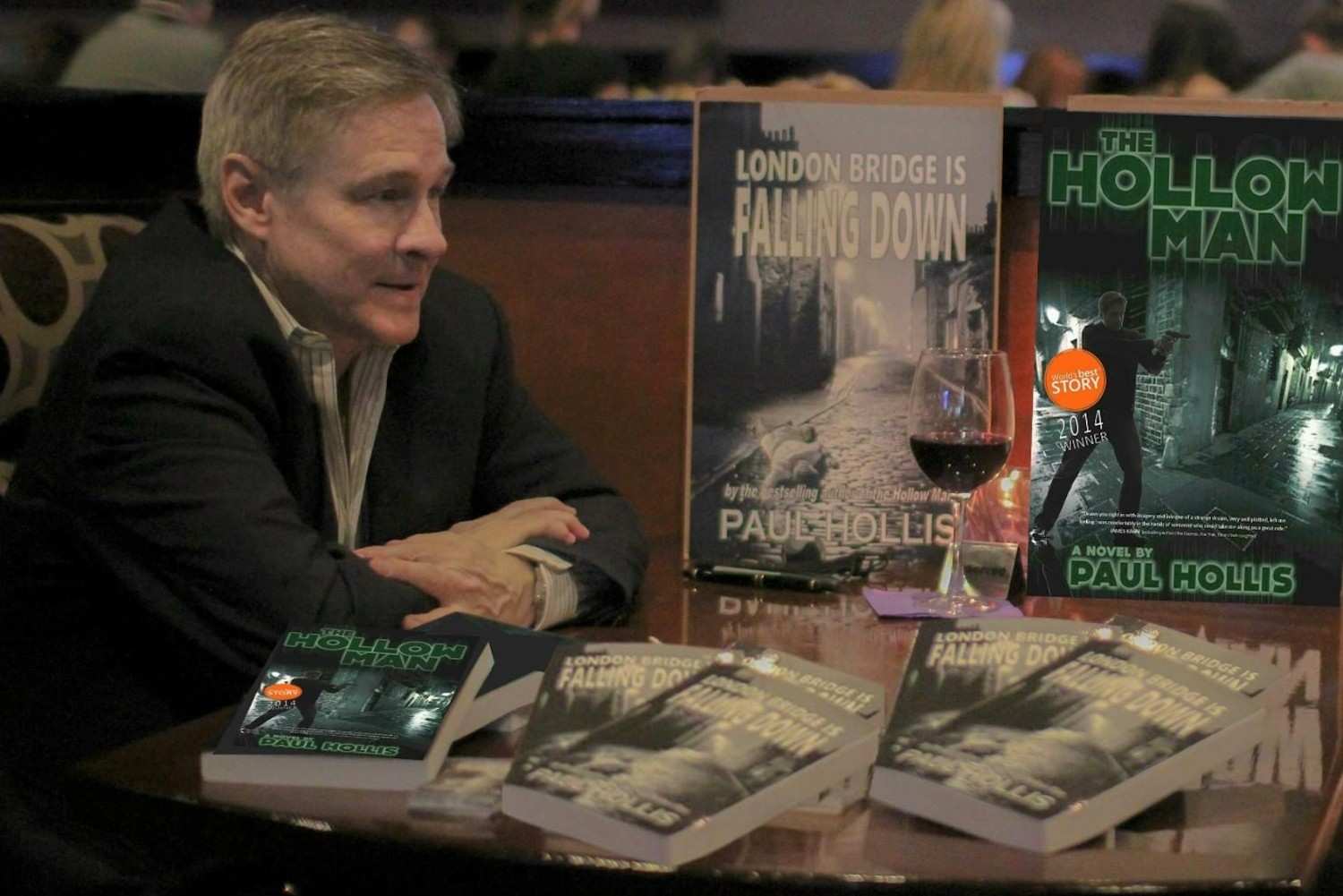Bestselling spy fiction author Paul Hollis chats with a fan at a booksigning at Whisky River in Jacksonville, FL