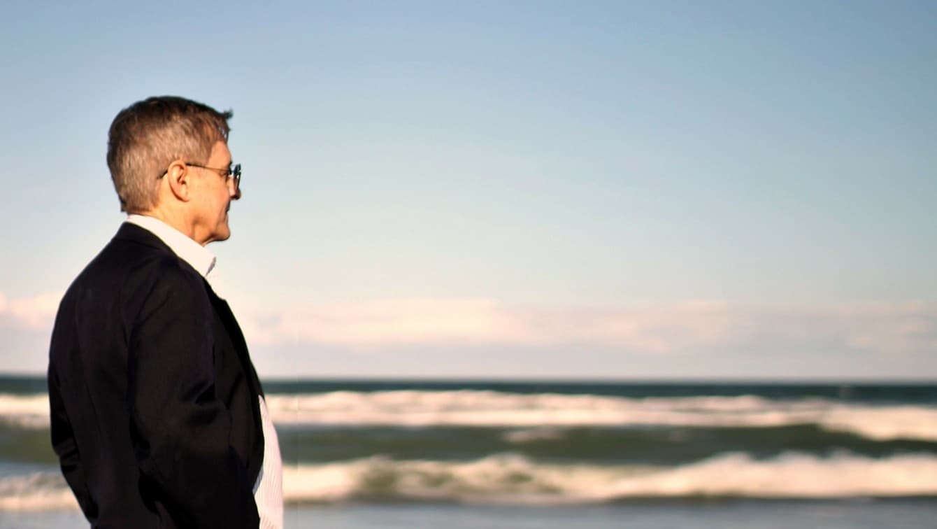 Bestselling spy thriller author Paul Hollis looking out over the ocean, featured on the Meet the Author page